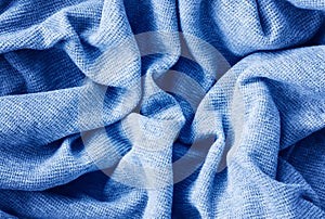 Closeup classic blue texture of knitted cotton waffle jersey material fabric or clothing. Toned trendy 2020 year colour background