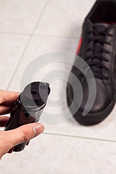 Closeup of cleaning black shoes with black paste