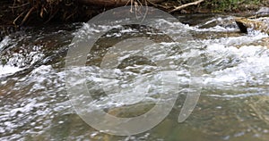 Closeup of clear water flowing in small mountain river