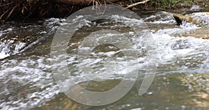 Closeup of clear water flowing in small mountain river