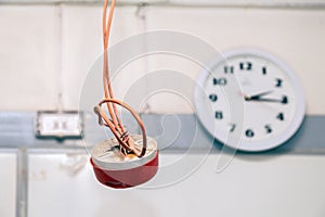 Closeup clock and installation and repair of electric cable, smoke detector, fire alarm system before installing. Concept testing