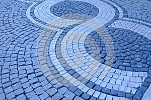 Closeup of a cobbled street. Grey paving stones. Cobblestones. Pavers. Space for text