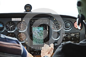 Closeup of a cockpit of cessna skyhawk 172 airplane with two pilots.