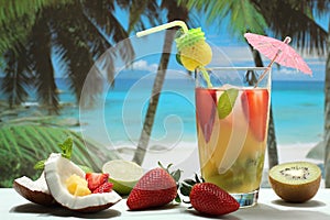 Cocktail with fruit on the beach photo