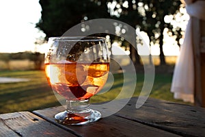 Closeup of a cocktail reflecting sundown outdoors