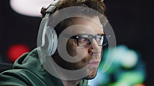 Closeup coder hands typing keyboard in night data center. Man enjoying music