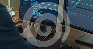 Closeup coding on screen, Man hands coding html and programming on two screen Monitors, development web, developer.