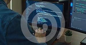 Closeup coding on screen, Man hands coding html and programming on two screen Monitors, development web, developer.