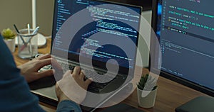 Closeup coding on screen, Man hands coding html and programming on two screen Monitors, development web, developer.