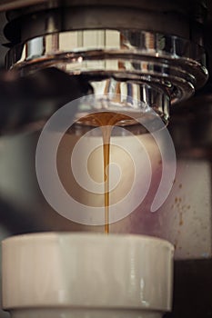 Closeup of coffee machine making espresso drink