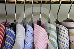 Closeup of collars of men's shirts hanging on a rail