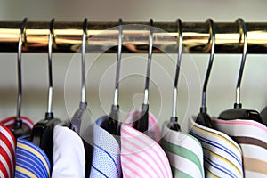 Closeup of collars of men's shirts hanging on a rail