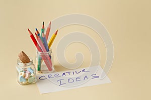 Closeup of color pencils in glass jar with notes