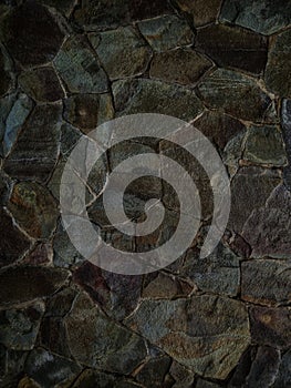 closeup of color saturation, pattern and texture of stone surface on exterior wall of building