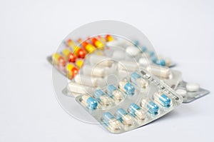 Closeup colorful antibiotics capsule pills in blister pack Pharmacy background.