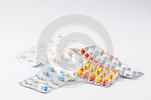 Closeup colorful antibiotics capsule pills in blister pack Pharmacy background. Pharmaceutical