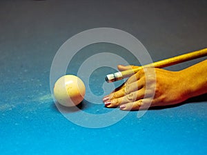 Closeup of colorful billiard balls on blue pool table in daylight