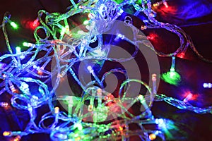 Closeup of colorful Christmas lights on a fabric - cool for backgrounds and wallpapers