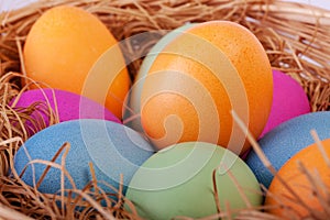 Closeup of colorful easter eggs in the nest