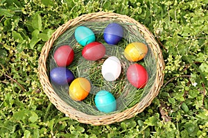 Closeup of colorful eggs in beautiful spring meadow on easter holiday outdoors in green graas.Traditional symbol for christian and