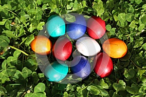 Closeup of colorful eggs in beautiful spring meadow on easter holiday outdoors in green graas.Traditional symbol for christian and