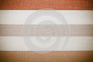 Closeup of colorful gray orange white striped textile as background or texture