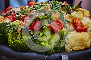 Closeup of colorful grilled vegetables in a cast iron kettle.