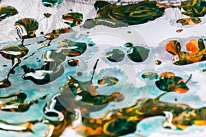 Closeup of colorful oil paint splashes on canvas. Abstract background.