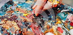 Colorful palette lefthanded artist mixing paint photo