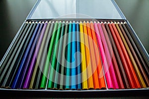 Closeup of colorful pencils in a metallic case