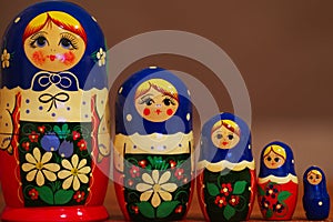 Closeup of colorful russian matryoshkas against blured brown background