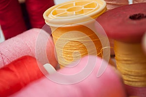 colorful sewing thread spool bobbins on white background