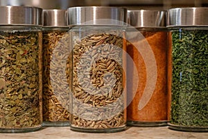 Closeup of colorful spice jars neatly organized in a pantry