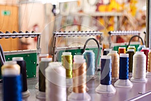 Closeup Colorful Spool of Thread on the Sewing Equipment, Fabric and Textile Industry, Embroidery machine