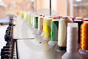 Closeup Colorful Spool of Thread on the Sewing Equipment, Fabric and Textile Industry, Embroidery machine