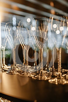 Closeup of colorful wine glasses.Wine glasses on a glass shelf with lighting. Empty crystal glasses close-up photo