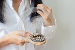 Closeup of comb brush with long loss hair .Woman loosing hair for head healthcare problem with copy space.