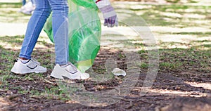 Closeup of a community service volunteer cleaning the park for an eco friendly planet. Responsible environmentalist or