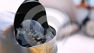 Closeup of a compass and deck of a wooden antique Sail boat navigating in the ocean sunny day showing the wooden parts and