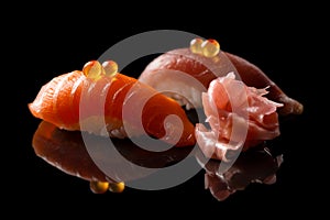 Closeup composition of two fresh salmon sashimi sushi with caviar