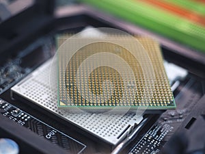 Closeup of computer CPU pins on motherboard socket, with contacts. Selective focus on CPU pins