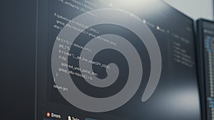 Closeup of computer display of software developer typing database functions script