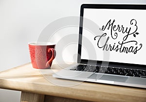 Closeup of computer laptop with Merry Christmas words
