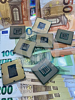 Closeup of computer microprocessors CPU on Euro banknotes. 100 Euro, 50 Euro, 200 Euro