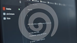Closeup of computer screen of software developer typing programming language