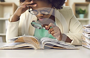 Closeup concentrated african american auditor scrutinizing financial documents