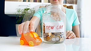 Closeup conceptual photo of saving money for buying new car