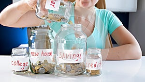 Closeup conceptual photo of young woman managing family budget and money savings