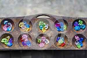 Closeup of a congkak or congklak which is a mancala game of Malay origin played in Malaysia, Philippines, Singapore, Indonesia,