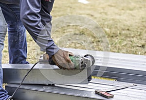 Closeup of construction workers' hands cutting steel